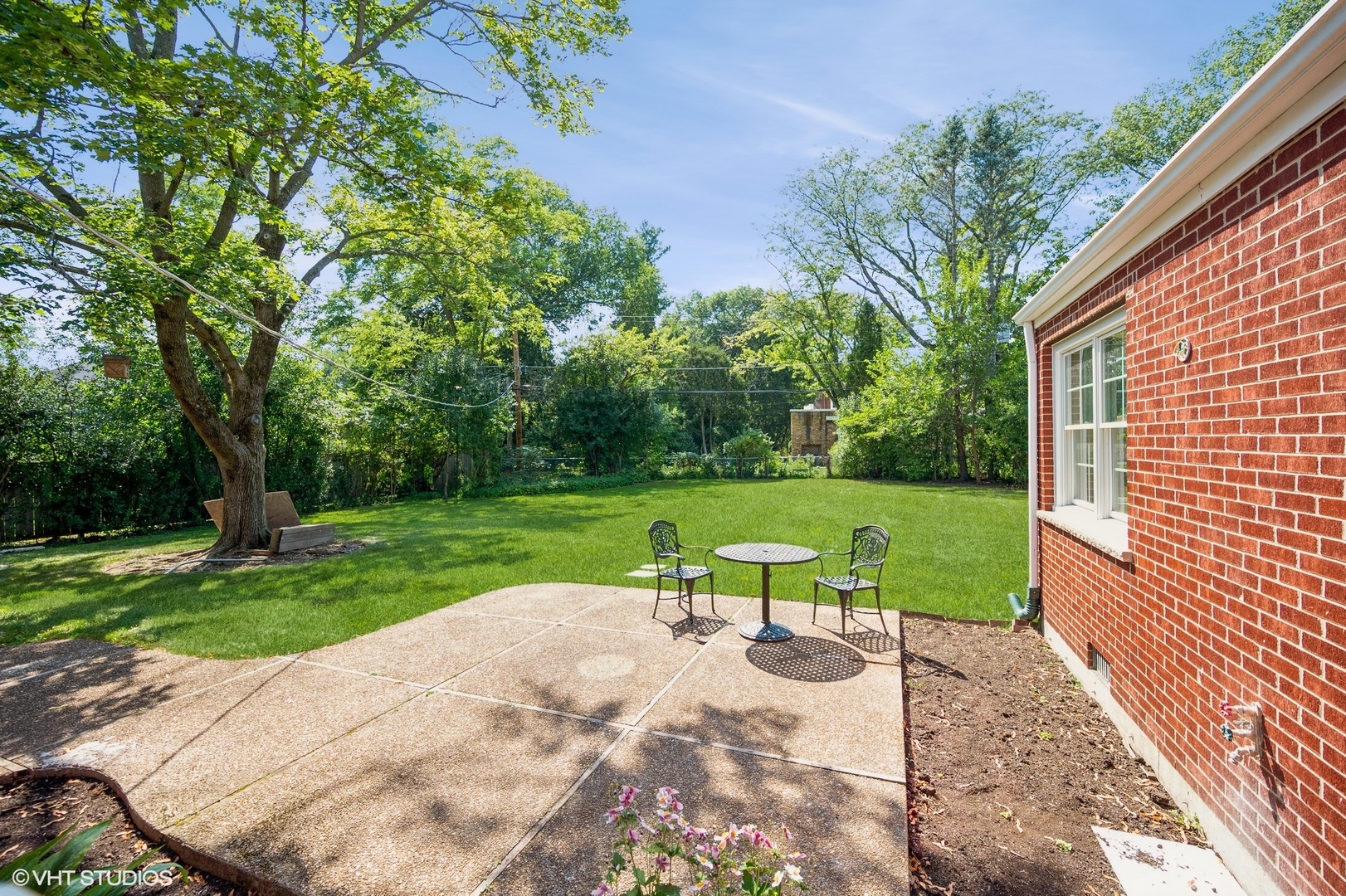580 North Happ Road Northfield, IL 60093 - Photo 17 of 20 a view of backyard with a garden and trees