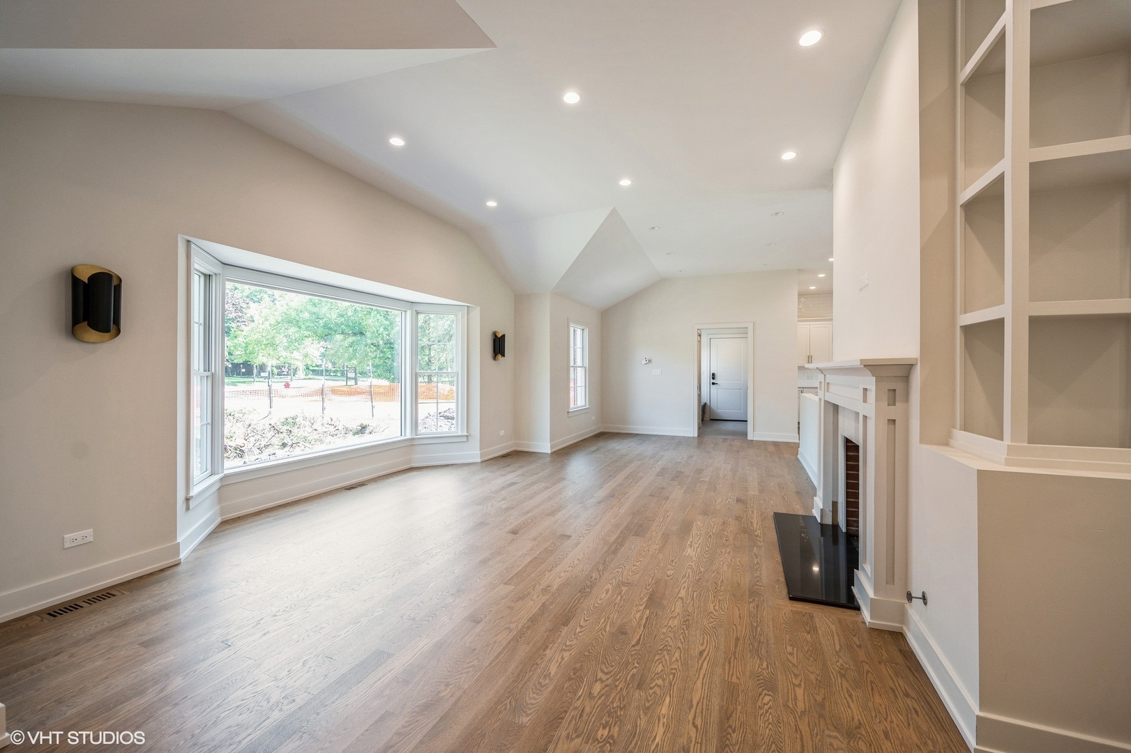 580 North Happ Road Northfield, IL 60093 - Photo 3 of 20 an empty room with wooden floor and a window