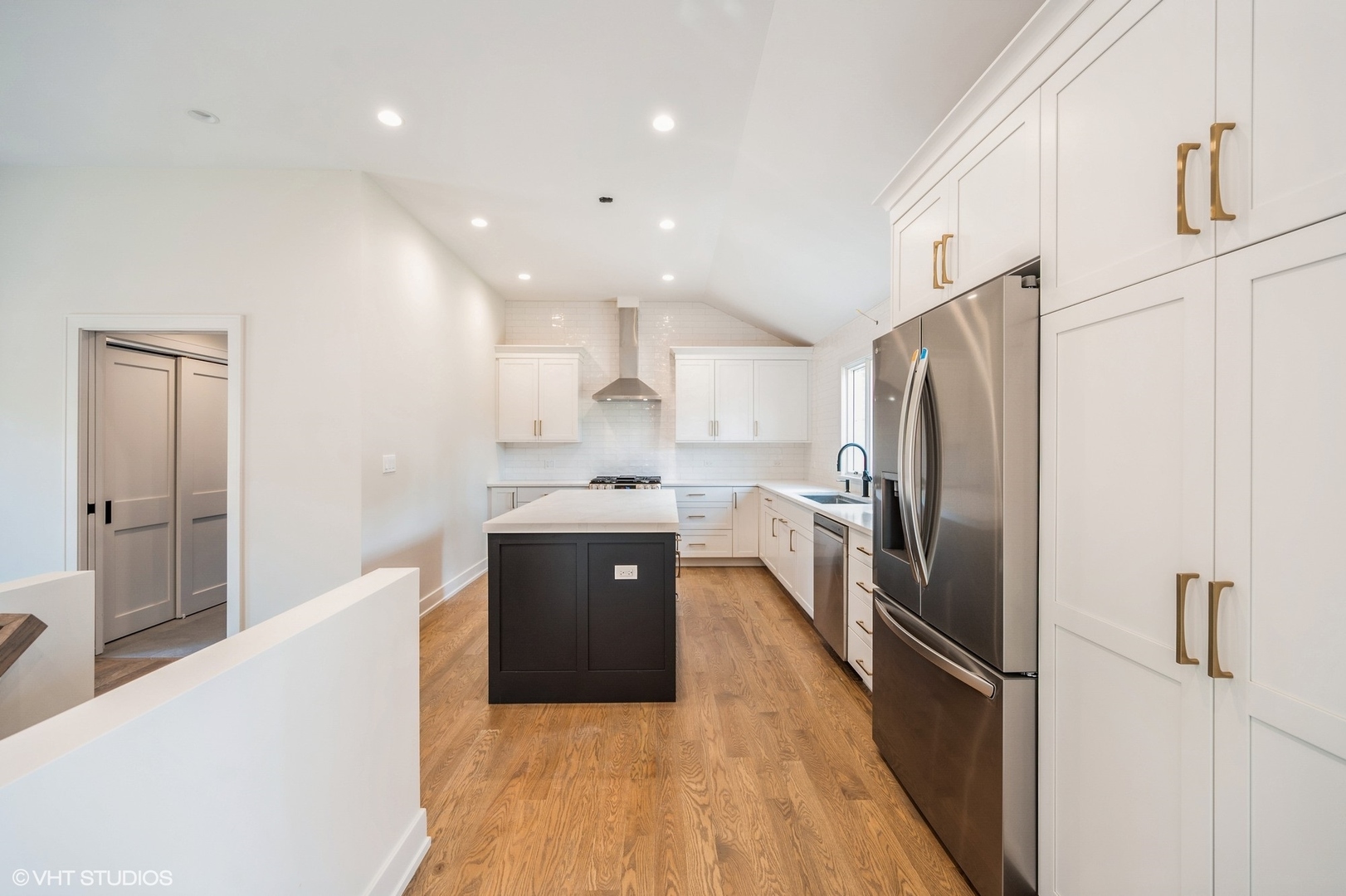 580 North Happ Road Northfield, IL 60093 - Photo 5 of 20 a large kitchen with stainless steel appliances granite countertop a refrigerator a sink dishwasher a stove and white countertops with wooden floor