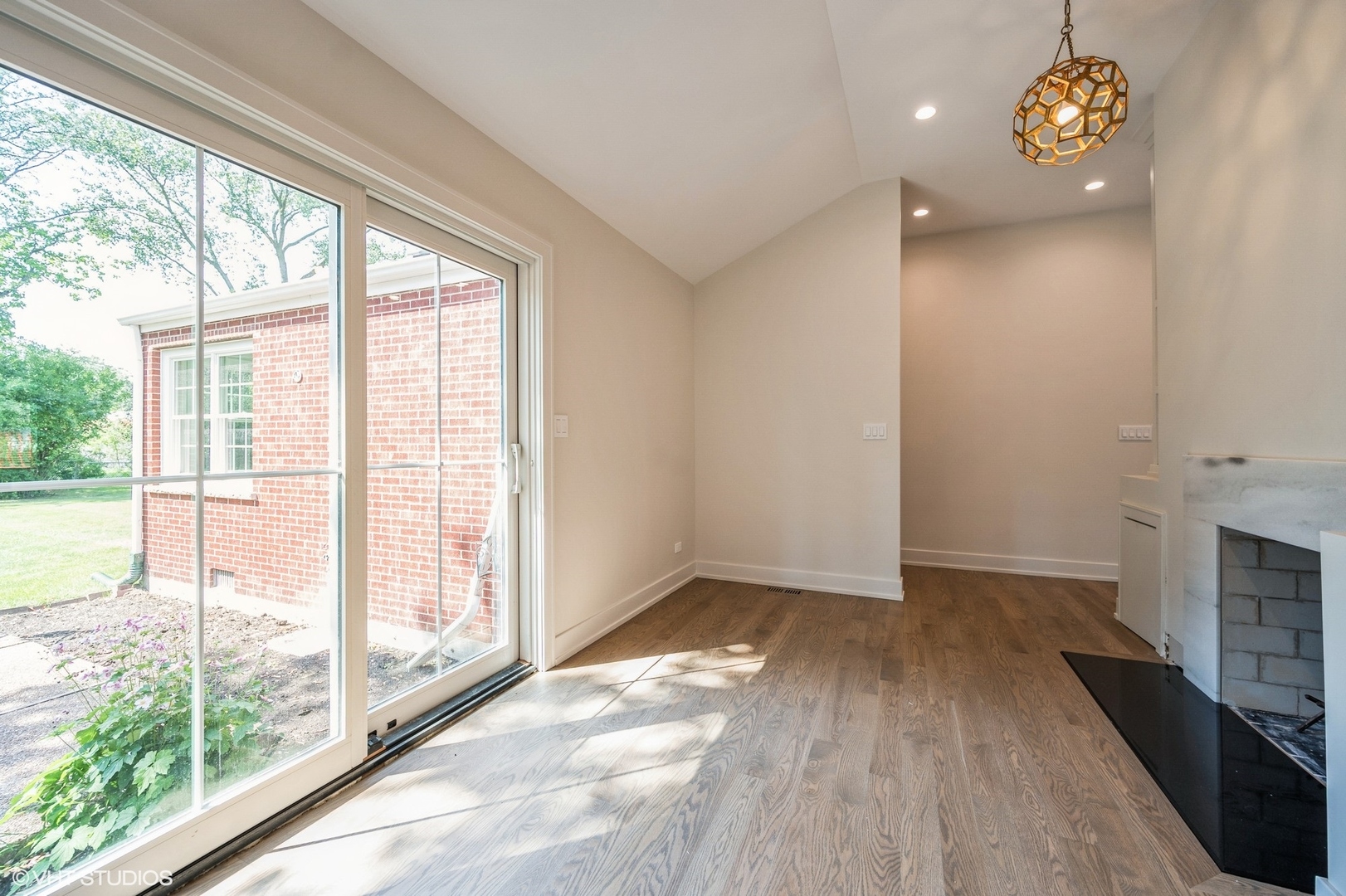 580 North Happ Road Northfield, IL 60093 - Photo 7 of 20 a view of an empty room with a window and wooden floor