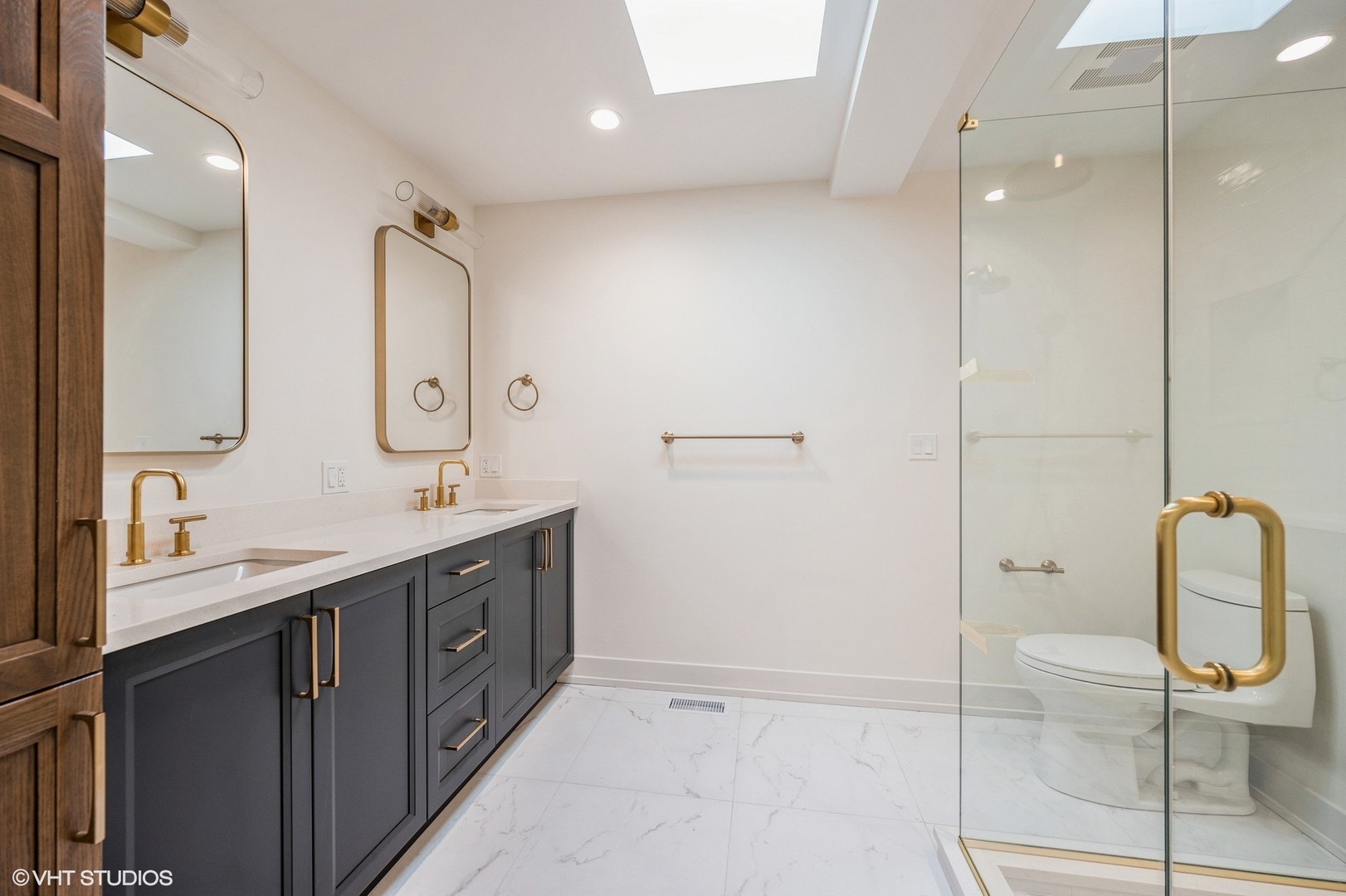 580 North Happ Road Northfield, IL 60093 - Photo 9 of 20 a spacious bathroom with a double vanity sink toilet mirror and shower