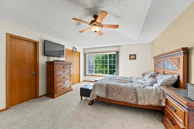 a bedroom with a bed and a chandelier