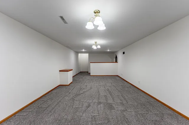 an empty room with a empty space and a ceiling fan