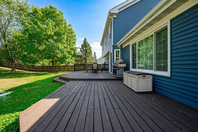 a view of a deck with wooden floor and outdoor seating