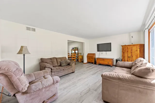 a living room with furniture and flat screen tv