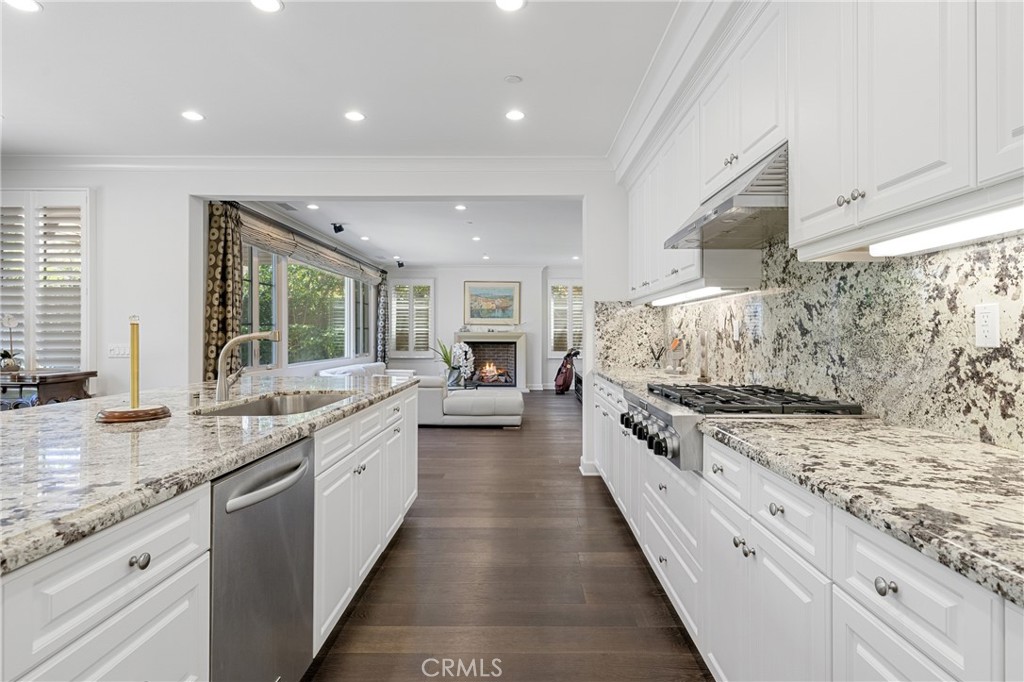 45 Triana Irvine, CA 92618 - Photo 12 of 39 a large kitchen with stainless steel appliances granite countertop a lot of counter space and wooden floor