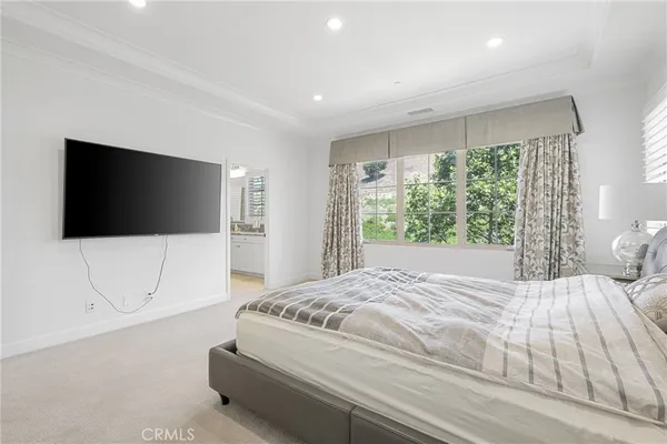 a spacious bedroom with a bed and a couch