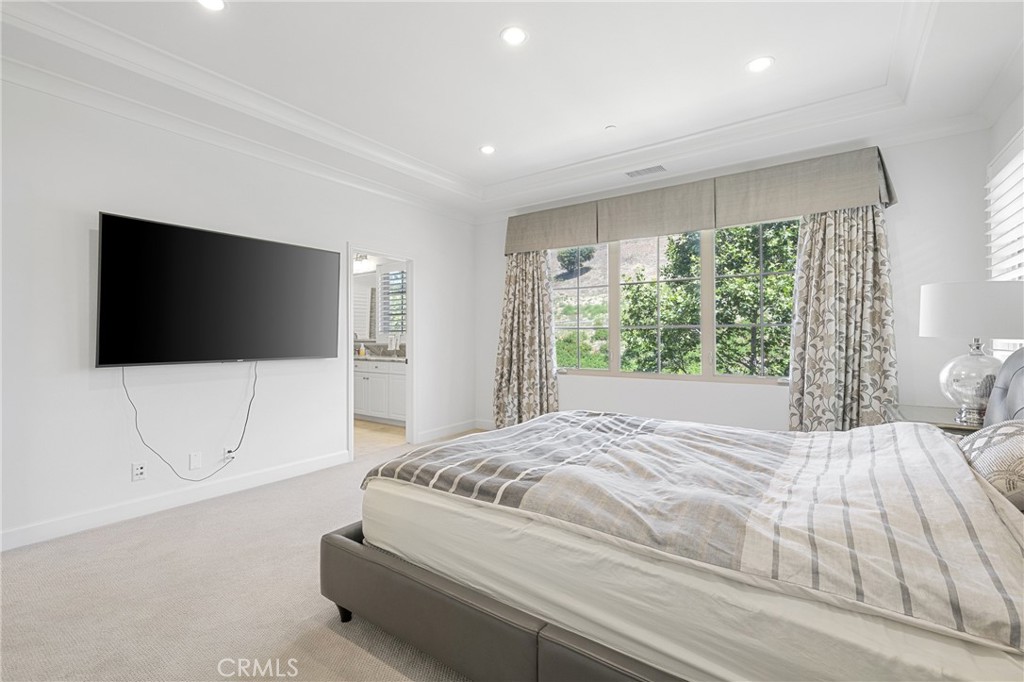 45 Triana Irvine, CA 92618 - Photo 22 of 39 a bedroom with a bed and a flat screen tv