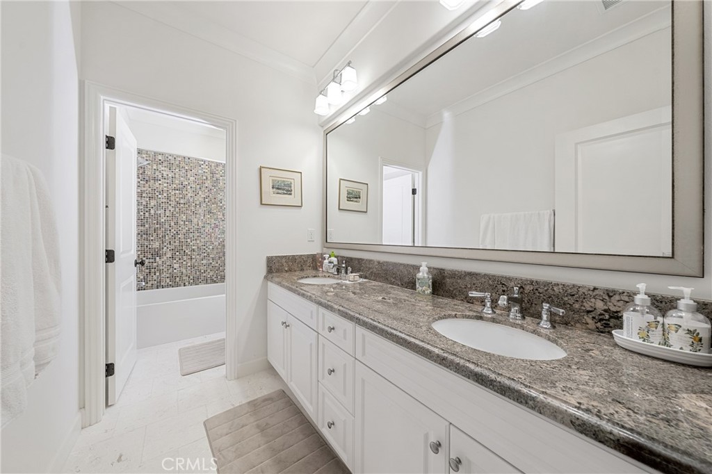 45 Triana Irvine, CA 92618 - Photo 28 of 39 a bathroom with a granite countertop sink double vanity granite tub shower and a mirror