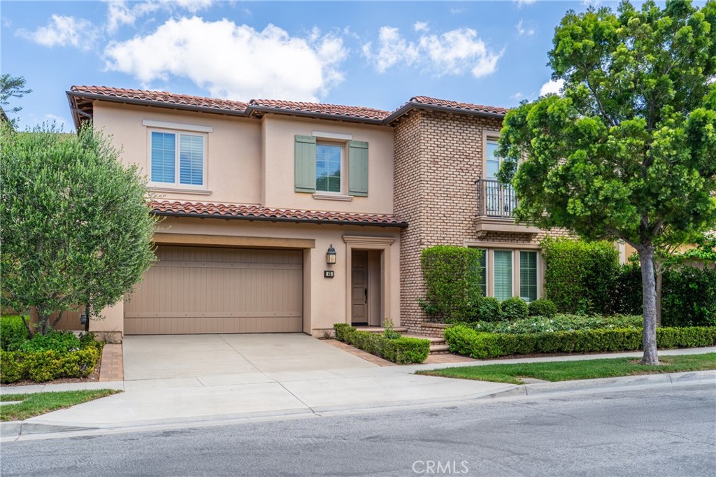 45 Triana Irvine, CA 92618 - Photo 4 of 39 a front view of a house with a yard and garage