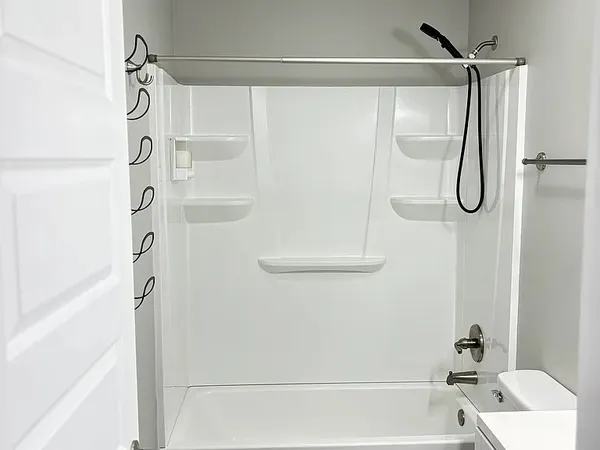 a bathroom with a shower and a bath tub