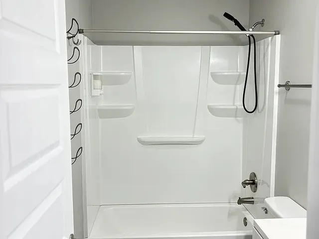 a bathroom with a shower and a bath tub