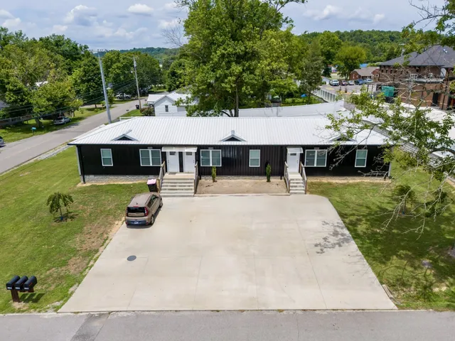an aerial view of a house with swimming pool garden and patio