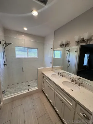 a bathroom with a sink and shower
