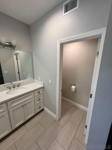 a kitchen with stainless steel appliances a sink a counter top space cabinets and wooden floor