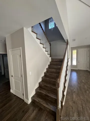 a view of a chandelier fan and entryway