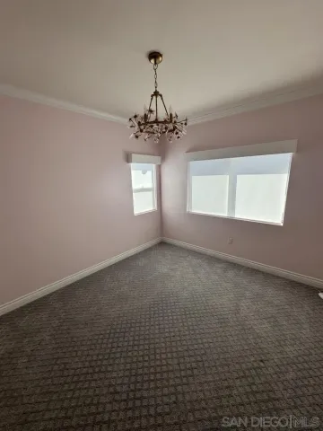an empty room with a cabinet and mirrors