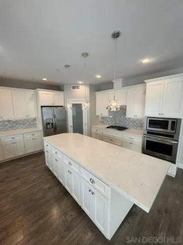 a large white kitchen with a large window