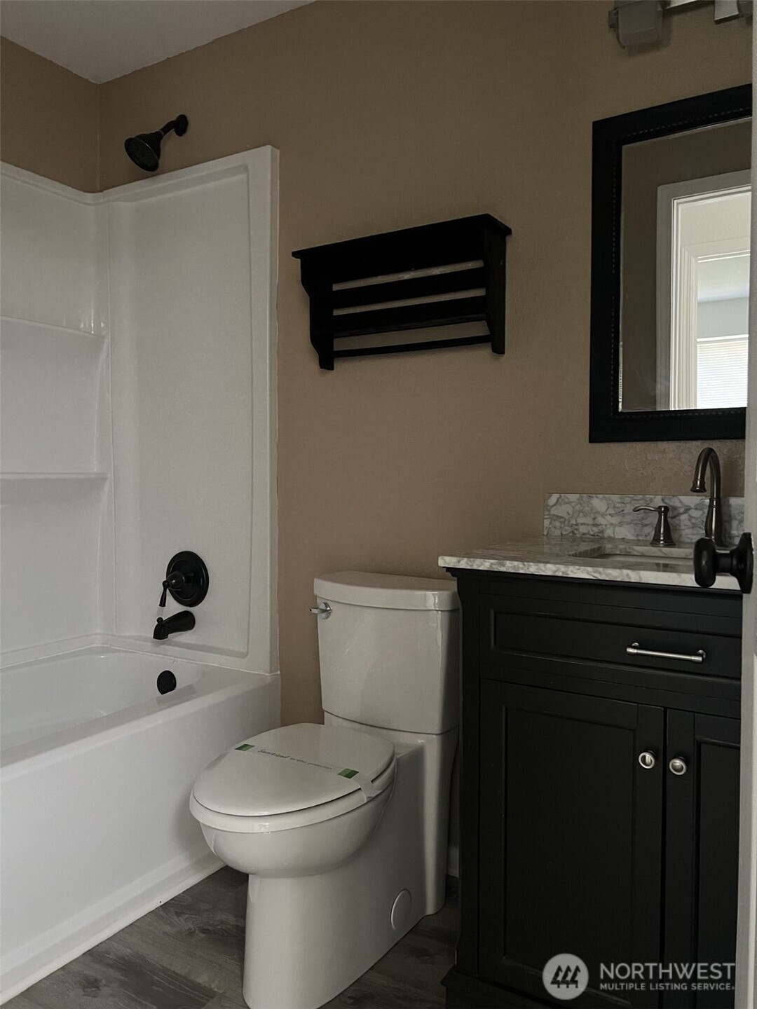 1124 Pinedrop Loop Southeast Olympia, WA 98513 - Photo 12 of 20 a bathroom with a sink a toilet and shower