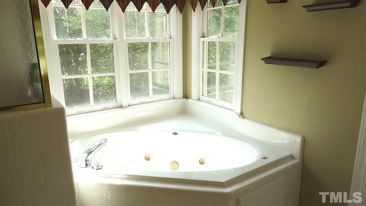 9209 Dawnshire Road Raleigh, NC 27615 - Photo 14 of 25 Separate whirlpool tub and custom tiled shower, freshly grouted!