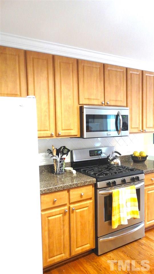 9209 Dawnshire Road Raleigh, NC 27615 - Photo 8 of 25 Gas stove and microwave, stainless steel