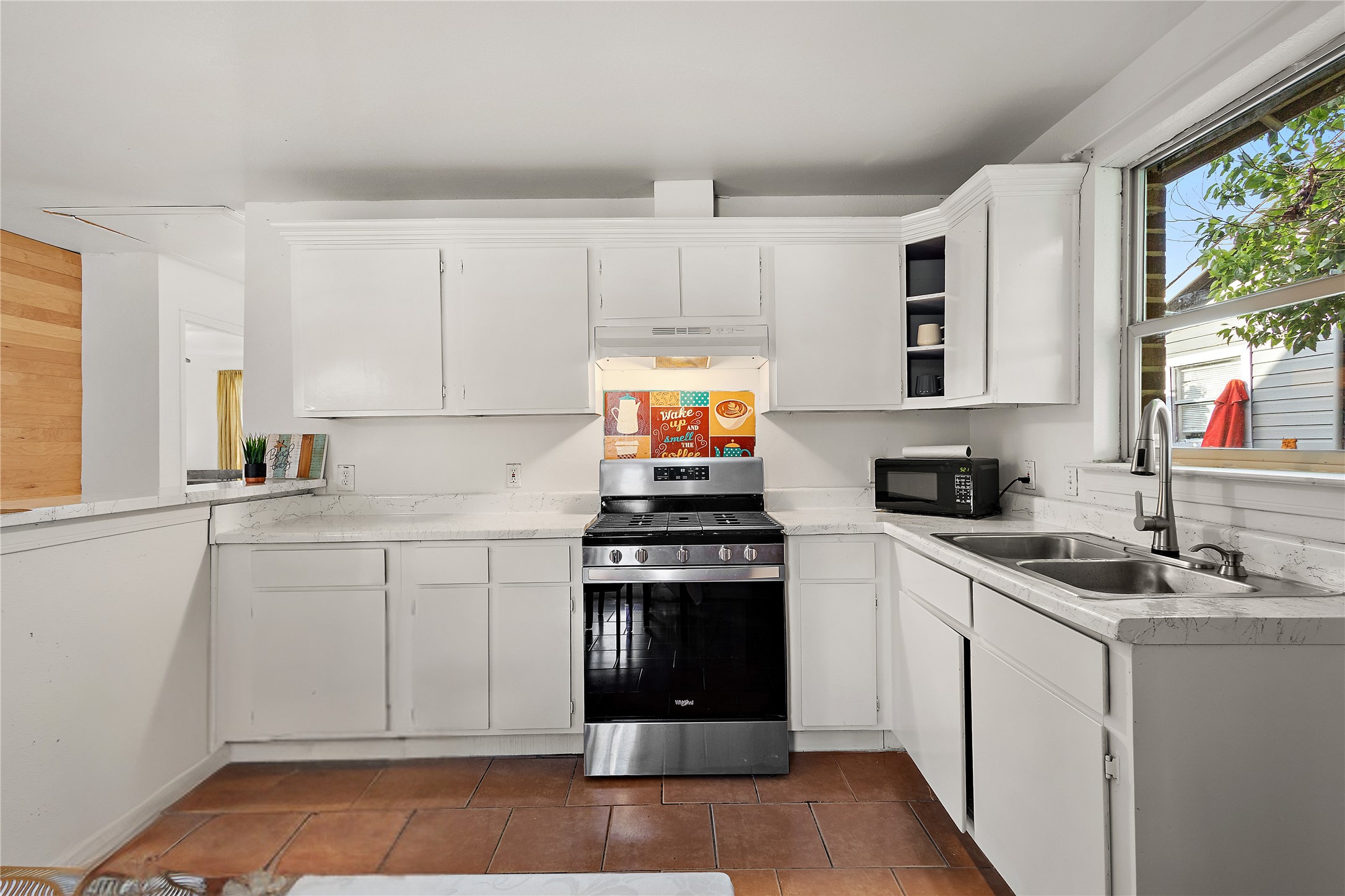 225 Palmyra Street Houston, TX 77022 - Photo 2 of 11 Bright, fully equipped kitchen featuring generous cabinetry, ample counter space, and everything you need for effortless everyday living.