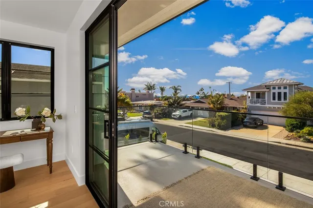 a room with lots of white furniture and a chandelier