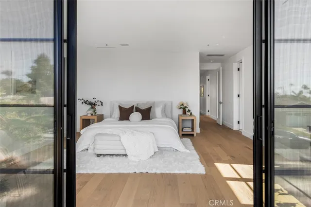 a spacious bedroom with a bed and glass door