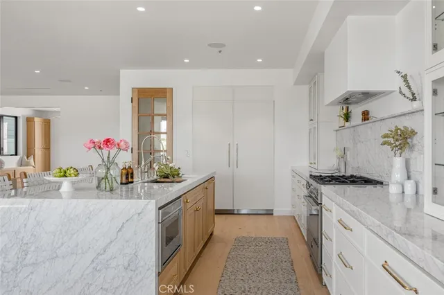 a kitchen with stainless steel appliances a sink stove and cabinets