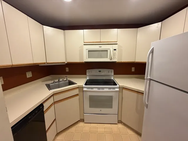a kitchen with a stove a refrigerator and a sink