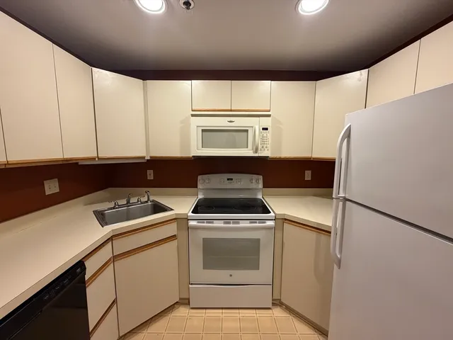 a kitchen with a stove cabinets and a refrigerator