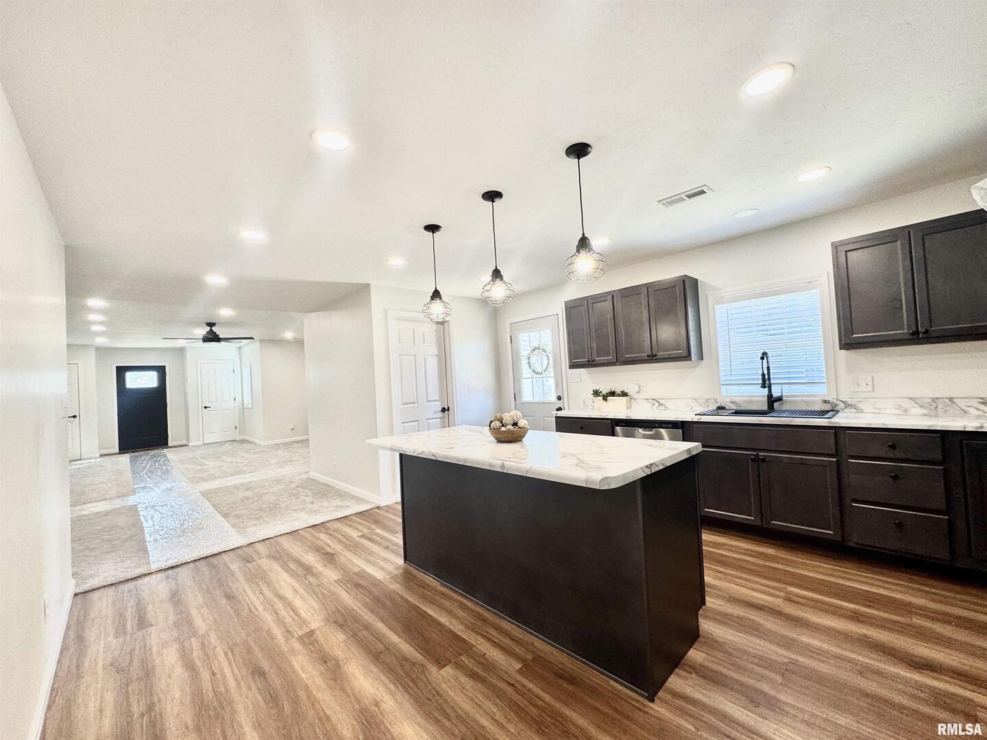 309 West Main Street Ewing, IL 62836 - Photo 11 of 37 a large kitchen with stainless steel appliances kitchen island granite countertop a sink and cabinets