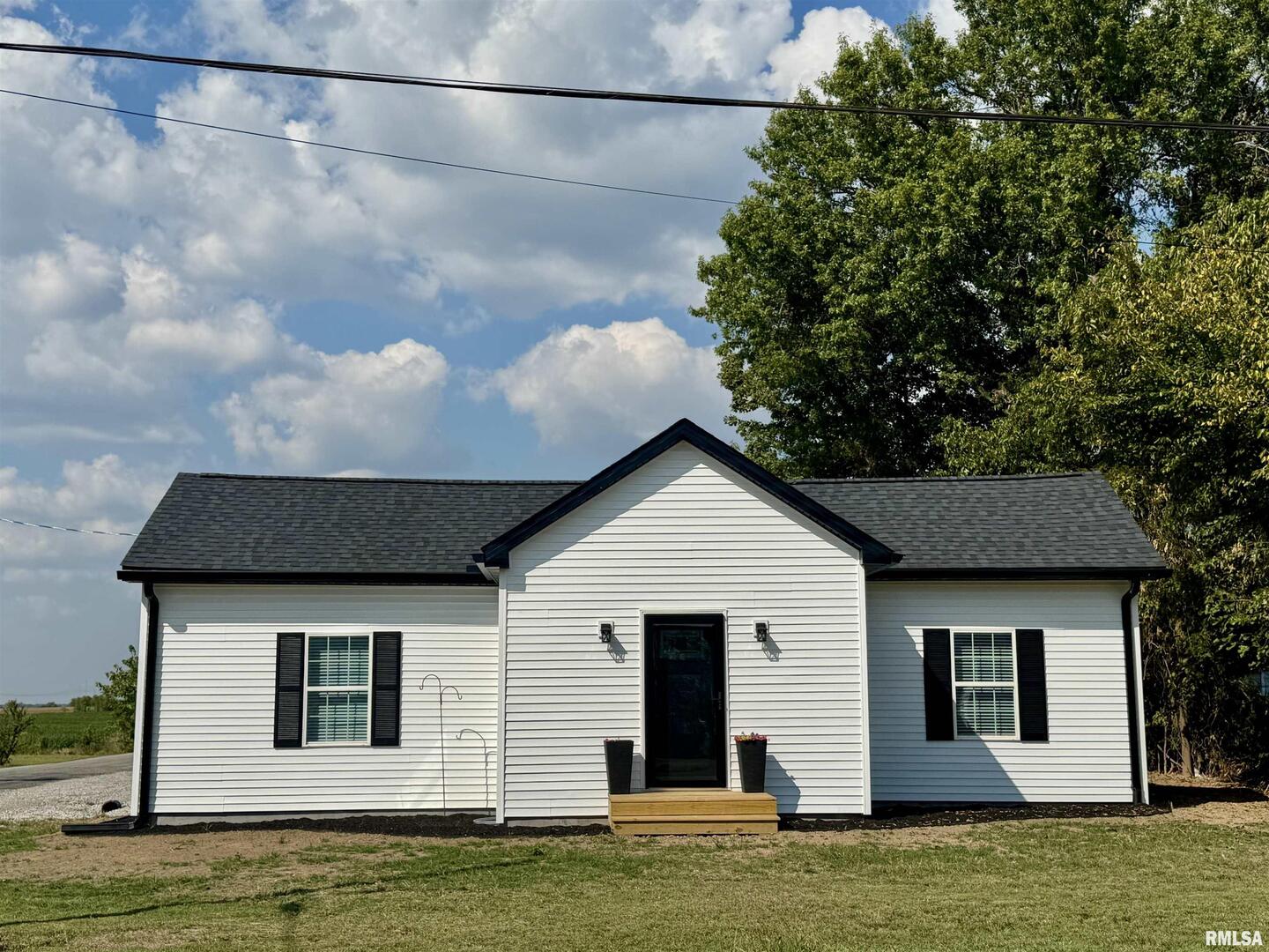 309 West Main Street Ewing, IL 62836 - Photo 3 of 37 a front view of a house with a yard