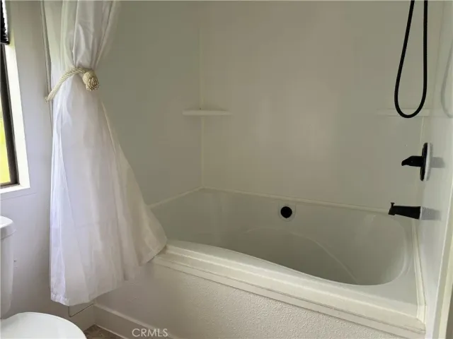 a bathroom with a shower and a toilet