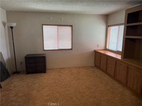 a room with a window and a dresser