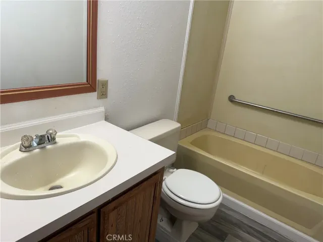 a bathroom with a sink a toilet and bathtub