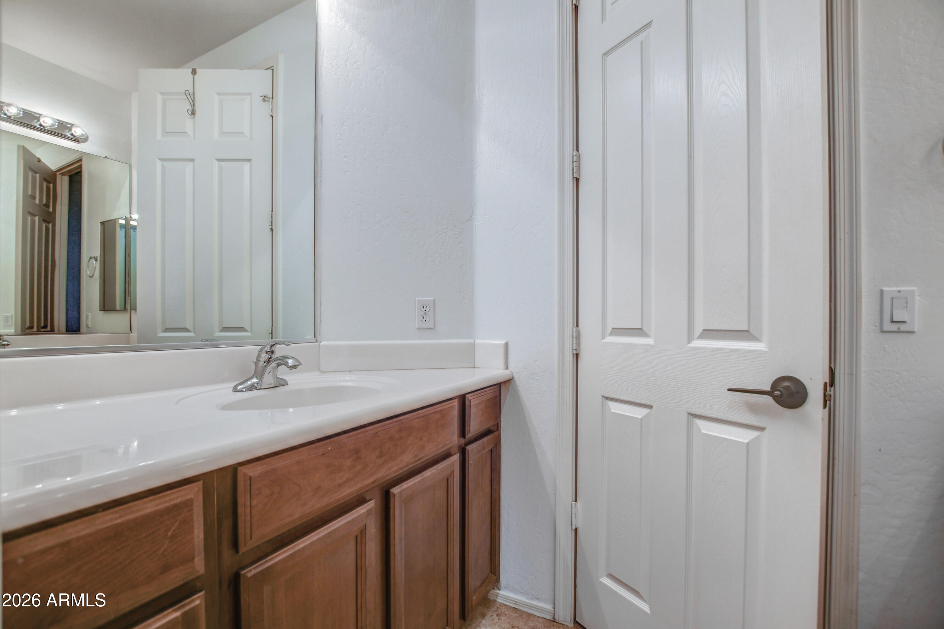 3078 East Muirfield Street Gilbert, AZ 85298 - Photo 76 of 92 a bathroom with a granite countertop sink and a mirror