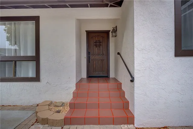 a living room with furniture a rug and a large window
