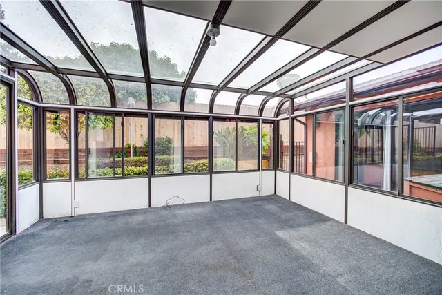 a view of a livingroom with wooden floor and a ceiling fan