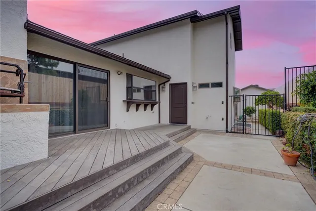 a view of a house with a porch and furniture