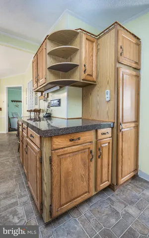 a kitchen with stainless steel appliances granite countertop a refrigerator and a stove
