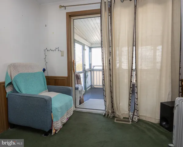 a living room with a bed and a mirror