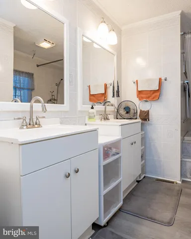 a bathroom with a sink double vanity and a mirror