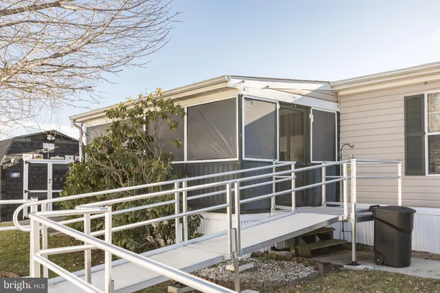 a wooden house with a large window and wooden fence