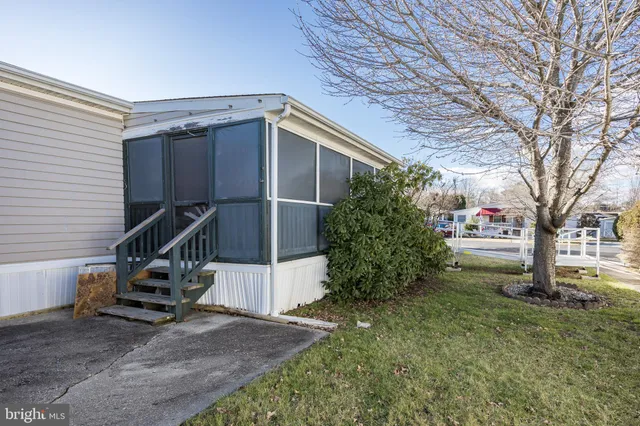 a view of a house with a tree in the yard