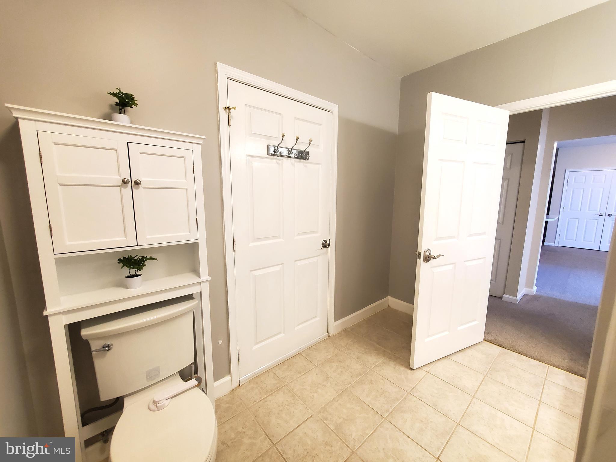 2433 Wentworth Drive Crofton, MD 21114 - Photo 13 of 18 a bathroom with a toilet a sink a vanity and mirror