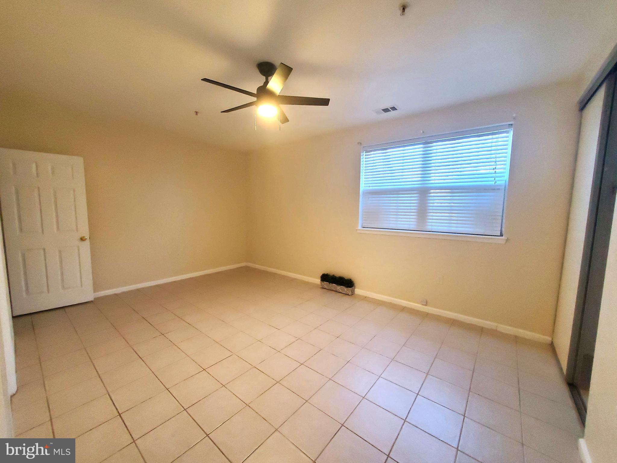 2433 Wentworth Drive Crofton, MD 21114 - Photo 14 of 18 an empty room with windows and fan