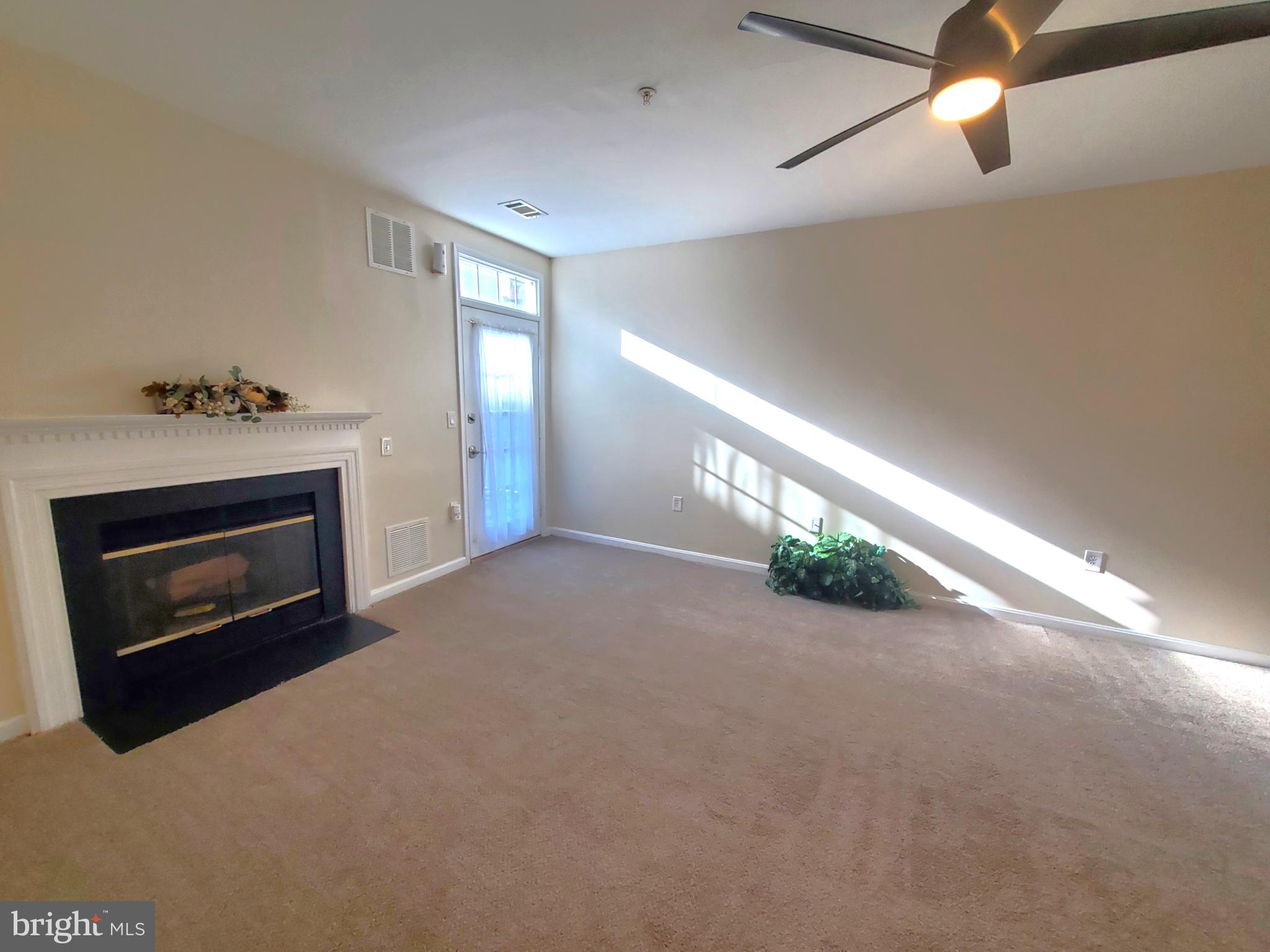 2433 Wentworth Drive Crofton, MD 21114 - Photo 8 of 18 a view of an empty room with a fireplace and a window