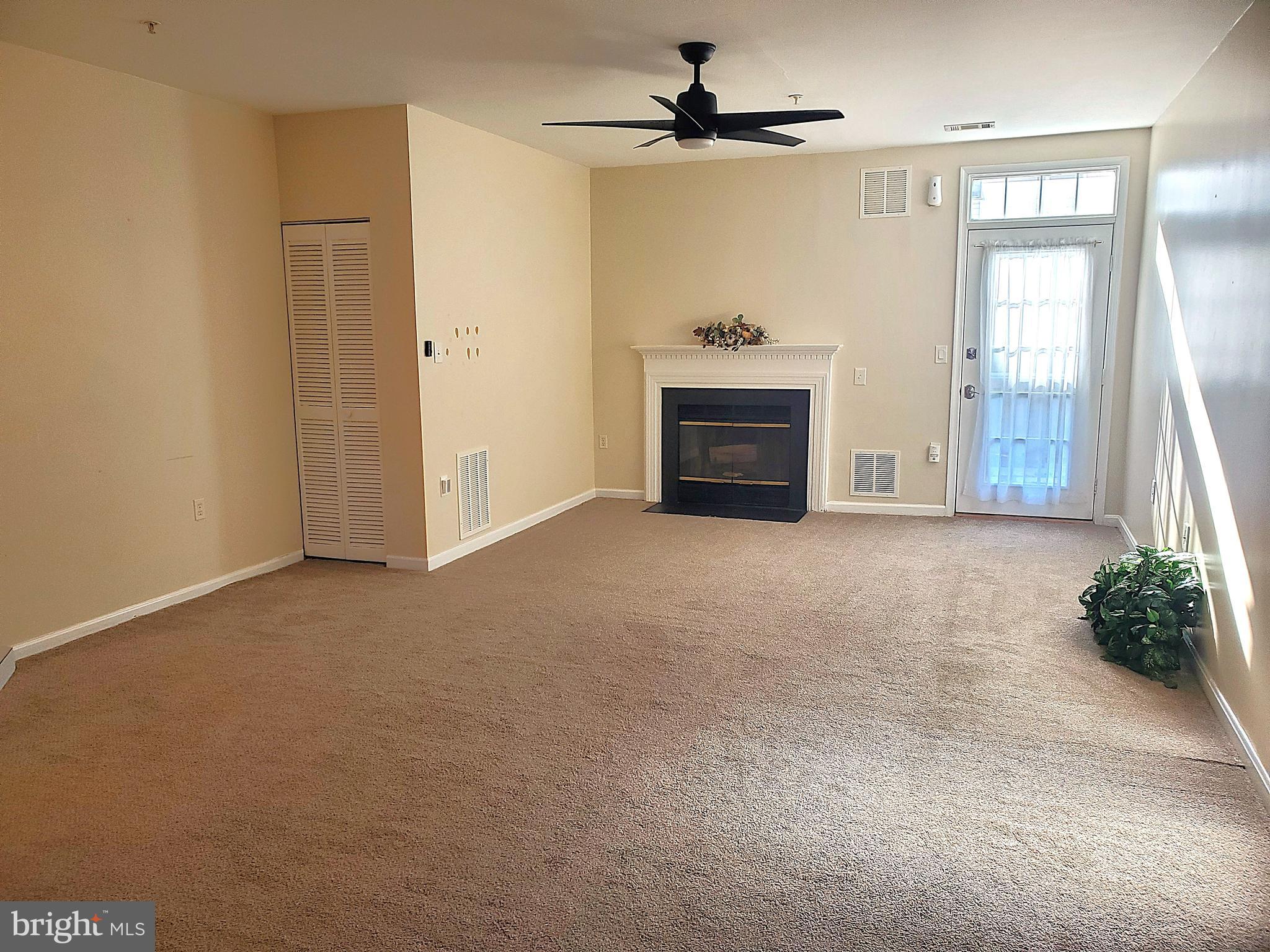2433 Wentworth Drive Crofton, MD 21114 - Photo 9 of 18 an empty room with windows and fireplace
