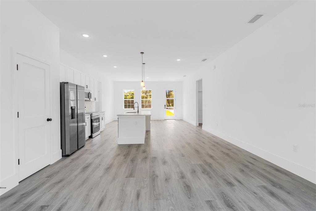 3428 Southwest 165th Loop Ocala, FL 34473 - Photo 16 of 43 a view of a big room with wooden floor and windows